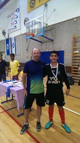 Image may contain: 3 people, people playing sports, people standing and basketball court